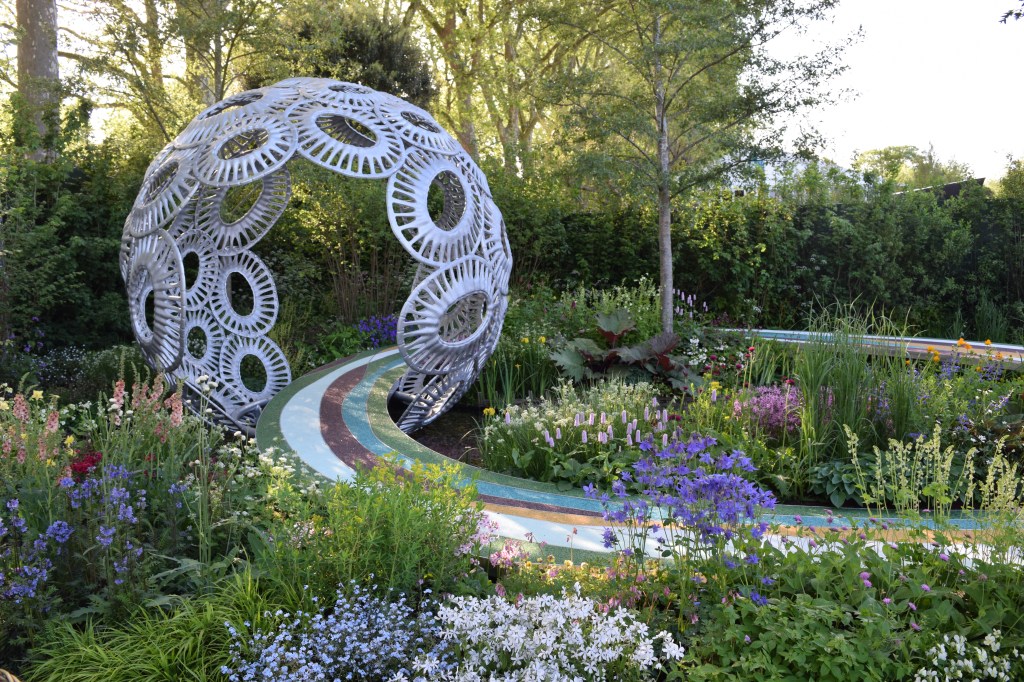 Garden at Chelsea with a large orb and colorful path
