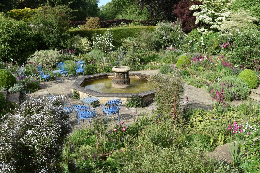 The White Sunk Garden (Number 3 on the Garden Map below) with central puntain and pool surrounded by French-blue furniture and silvery plants.