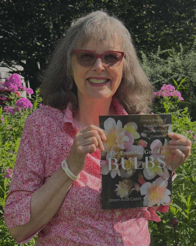 Jenny Rose Carey holding her new bulb book - The Essential Guide to Bulbs - released October 2025