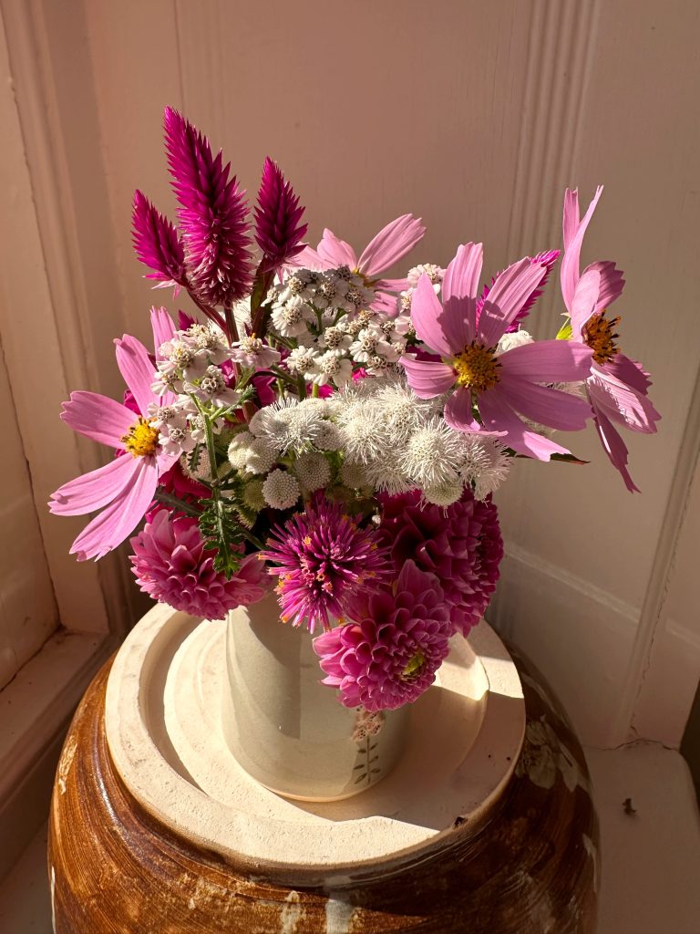 Small arrangement of flowers in pinks and maroons
